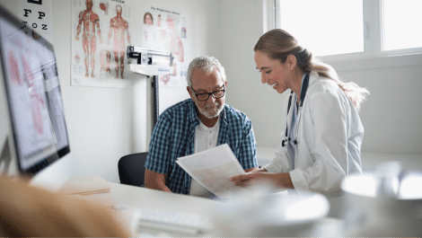 doctor giving documents to elderly patient